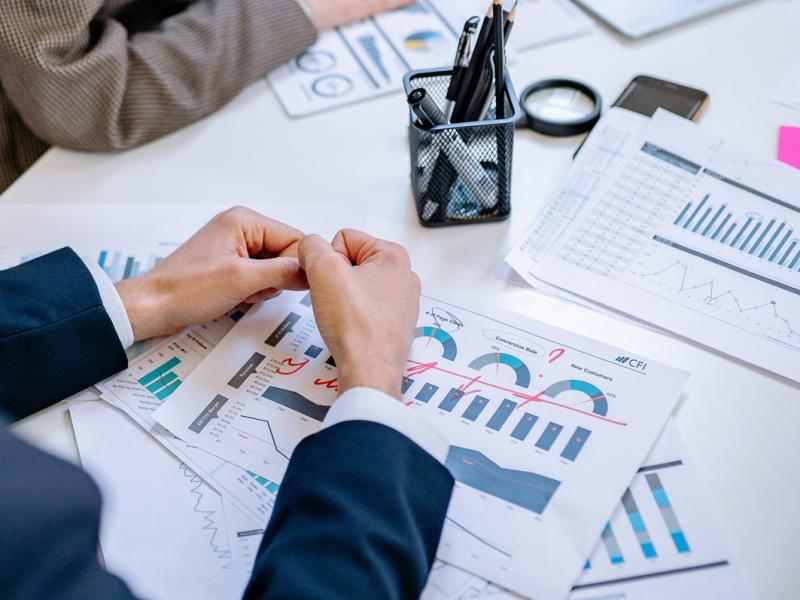 Financial reports srewn across desk